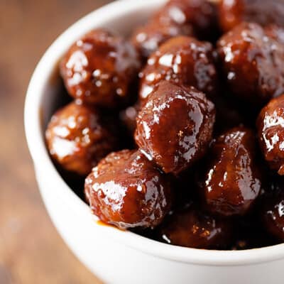 grape jelly meatballs in white bowl.