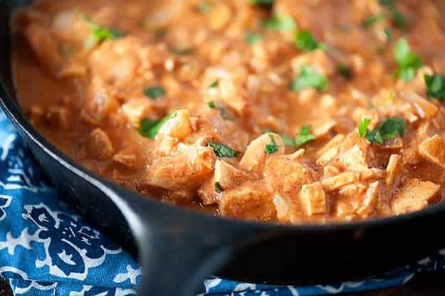 Indian butter chicken in a black cast-iron skillet.