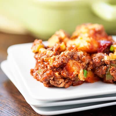 Three square plates topped with sloppy joe casserole.