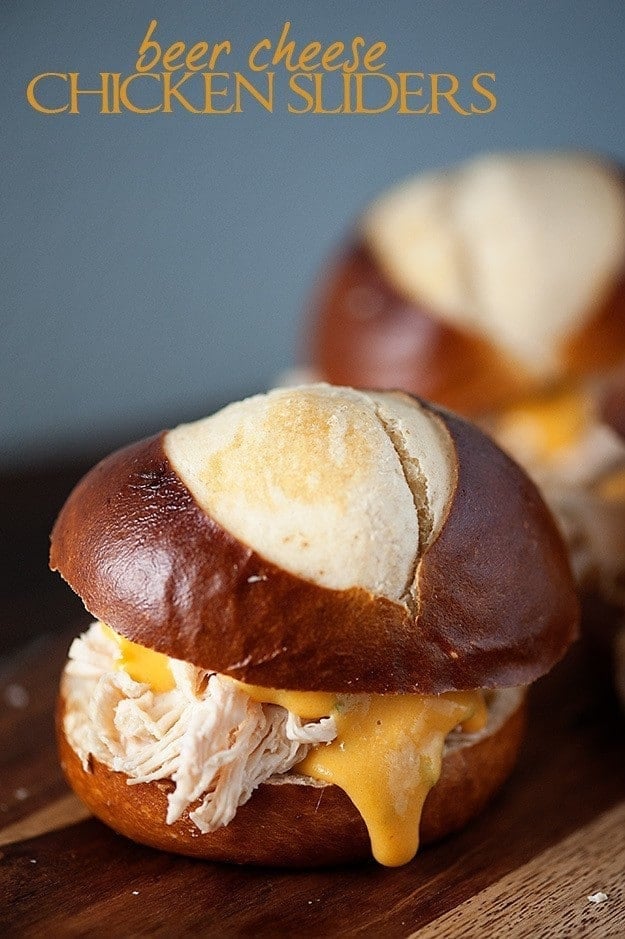 Beer Cheese Chicken Sliders - crockpot pulled chicken cooked in beer and topped with a beer cheese sauce!