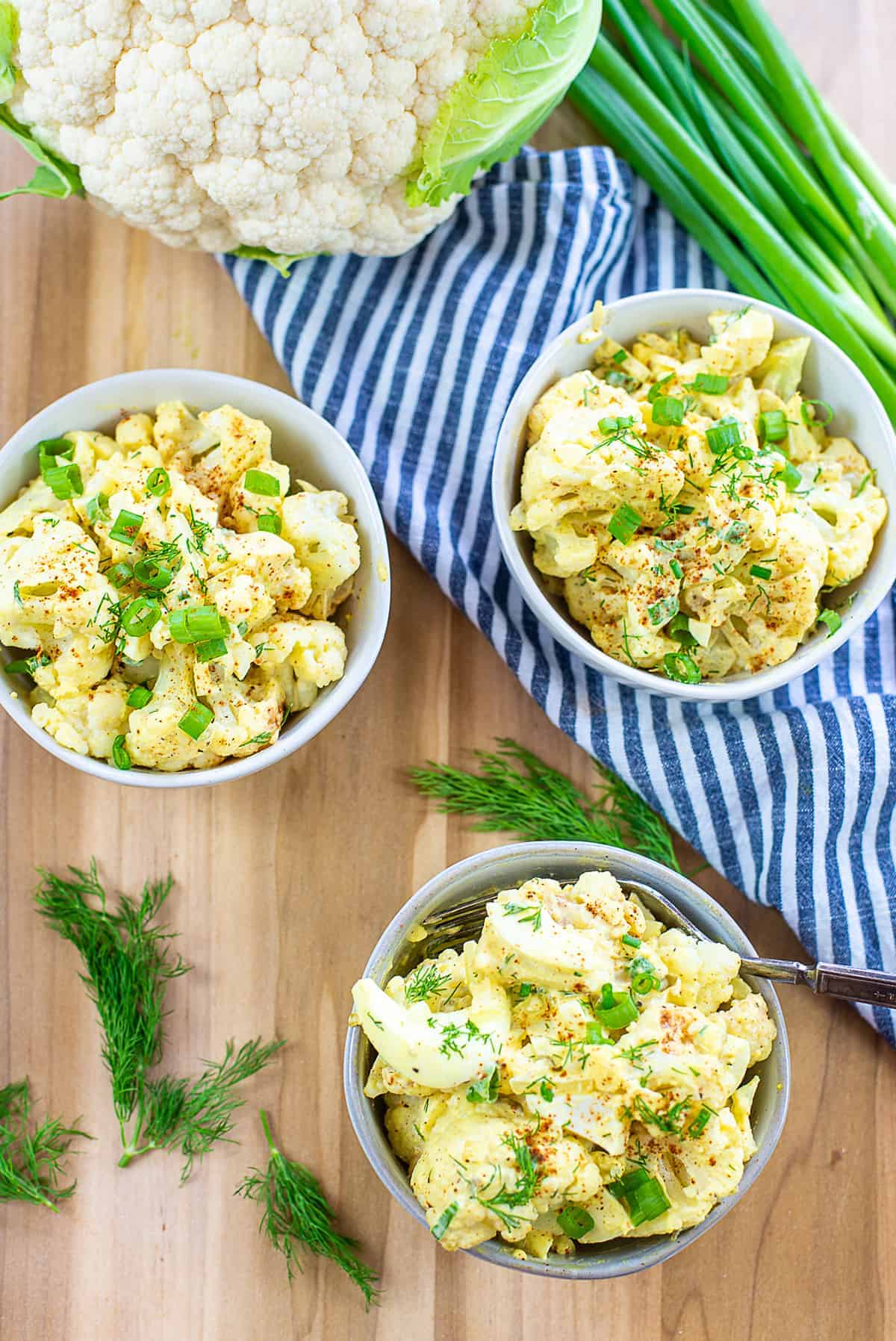 overhead view cauliflower potato salad in small bowls.