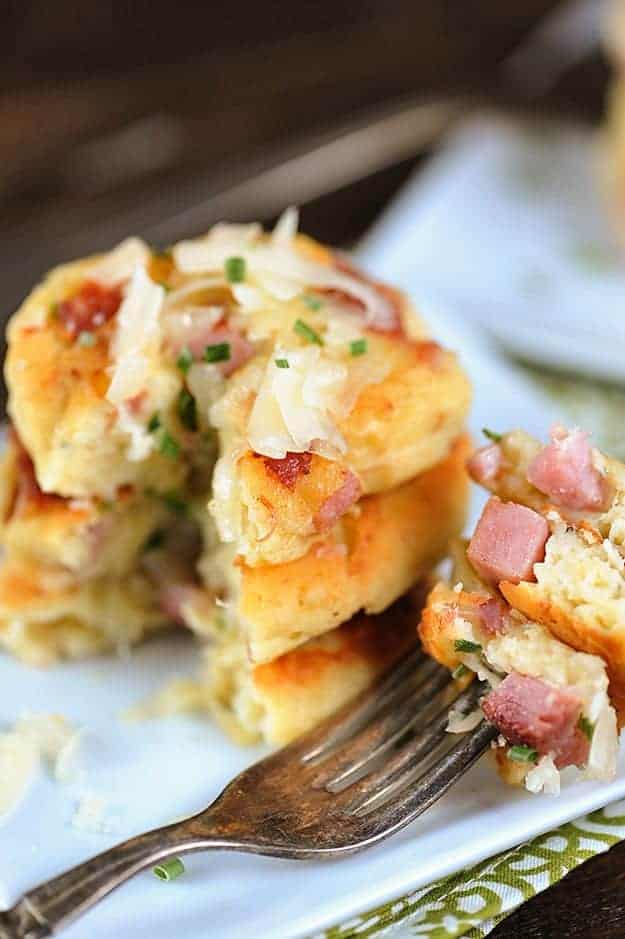 A bite removed from a stack of potato pancakes.