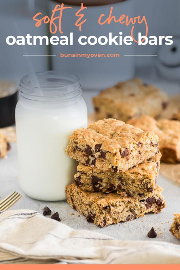 Chocolate chip oatmeal cookies next to glass of milk.