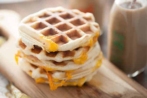 A stack of waffles with cheese in between them.