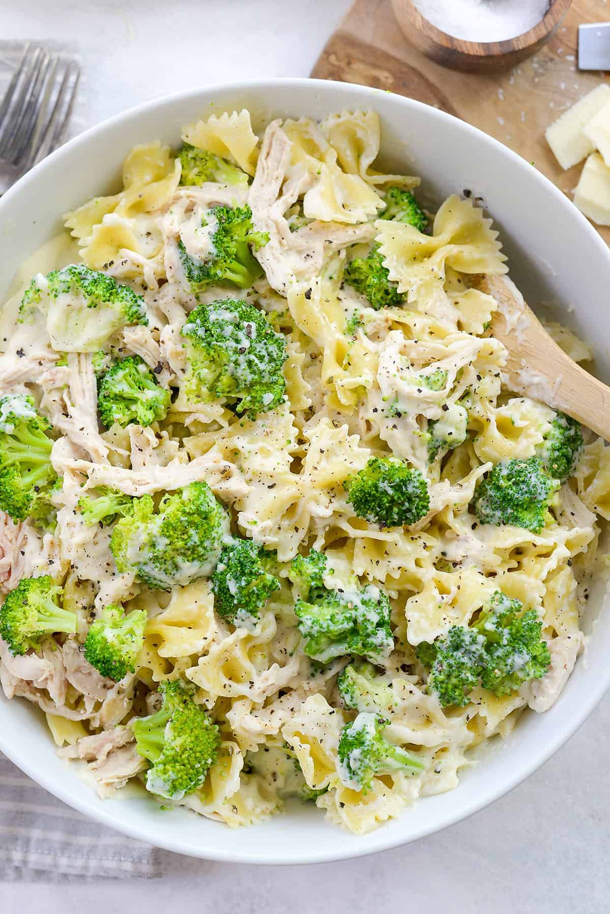 chicken broccoli pasta in white bowl.