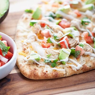 This quick and easy dinner recipe is ready in just 20 minutes! Mexican Chicken Flatbread... healthy, quick, and loaded with chicken, cheese, and pico de gallo!