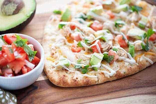 This quick and easy dinner recipe is ready in just 20 minutes! Mexican Chicken Flatbread... healthy, quick, and loaded with chicken, cheese, and pico de gallo! 