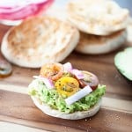 These English muffins are topped with smashed avocados, pickled onions, and cherry tomatoes for a quick breakfast or snack recipe that is filling and satisfying!