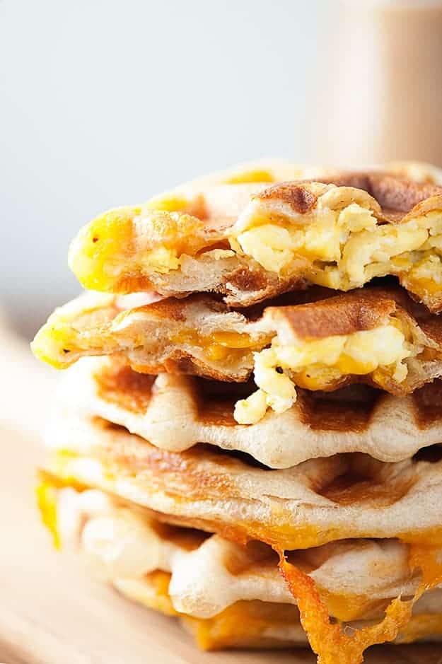 A stack of waffles stuffed with eggs and cheese.