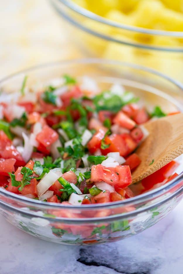 pico de gallo in glass mixing bowl.