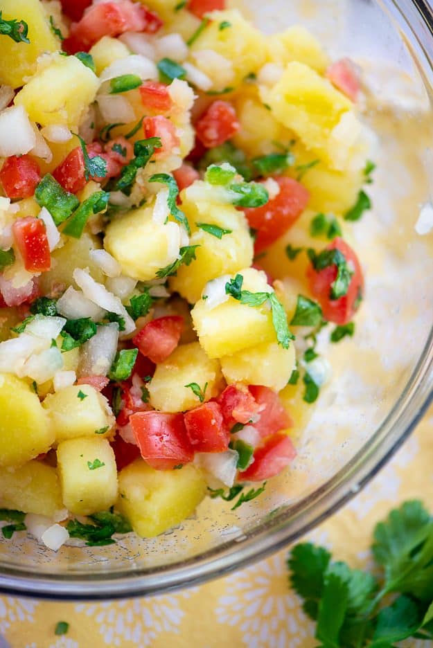 potato salad with pico de gallo in glass bowl.