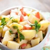 There is no mayo in this bright and refreshing potato salad recipe! It's light, healthy, and perfect for a hot summer day!