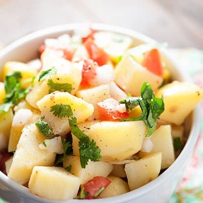 There is no mayo in this bright and refreshing potato salad recipe! It's light, healthy, and perfect for a hot summer day!