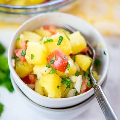 Mexican potato salad in stacked white bowls.