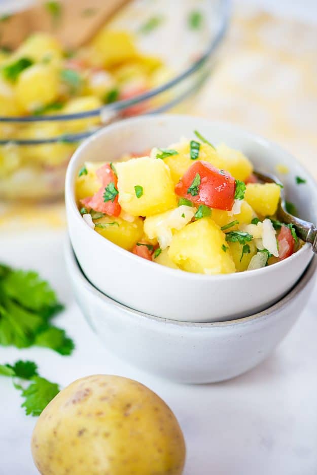 Potato salad without mayo in white bowl.