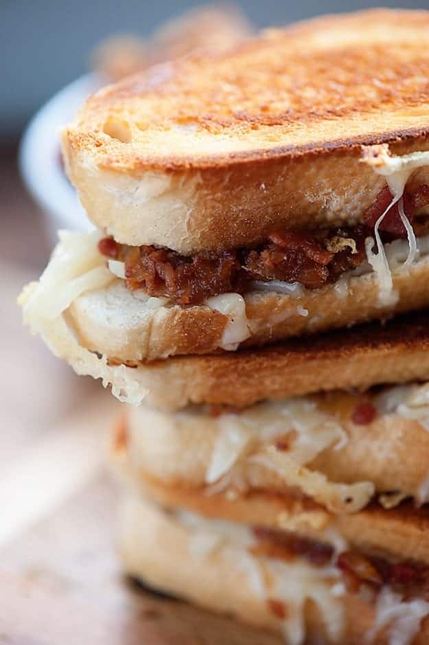 A close up of stacked grilled cheese sandwiches.