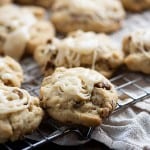 Cookies topped with icing on a wire cooling rack.