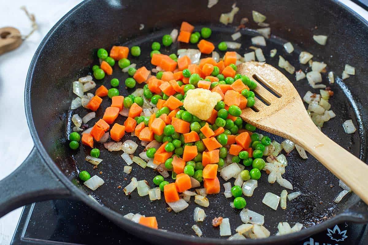 veggies cooking in skillet.