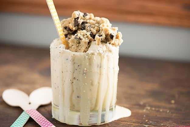 Cookie dough on top of a glass of ice cream.