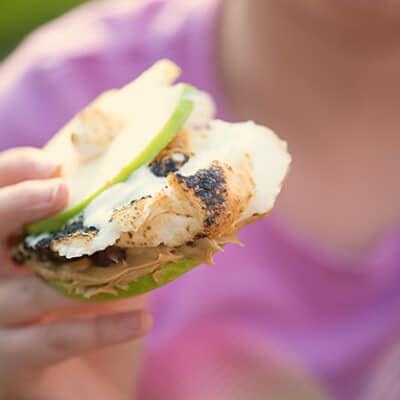 S'mores made with apple slices, peanut butter, and chocolate chips!