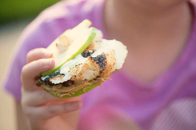 S'mores made with apple slices, peanut butter, and chocolate chips! 