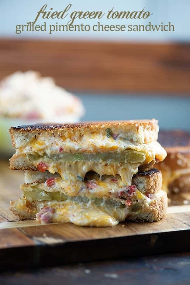 Two stacked halves of grilled tomato and cheese sandwich.