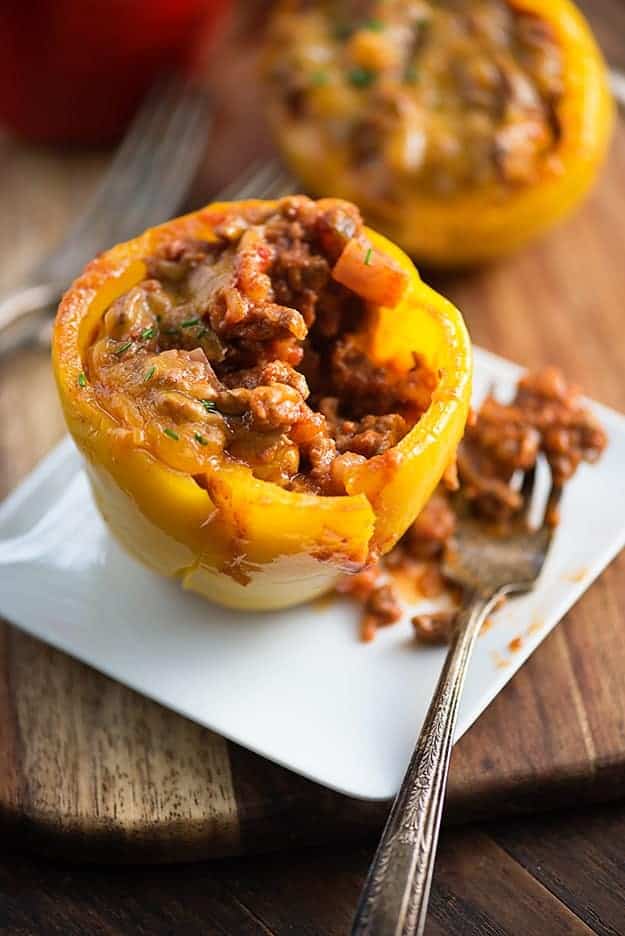 A stuffed pepper on a white plate with a fork.