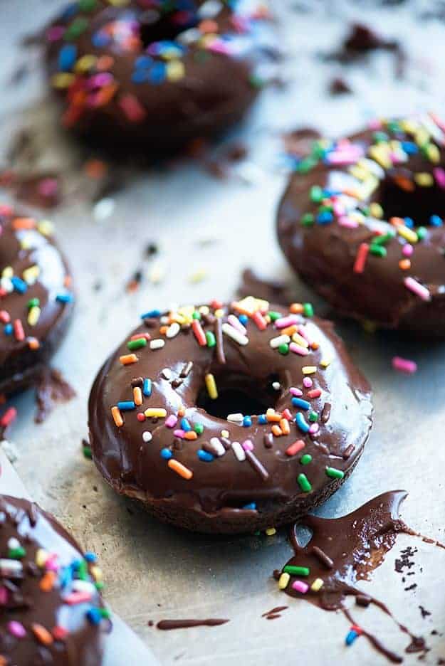 A chocolate covered donut with sprinkles