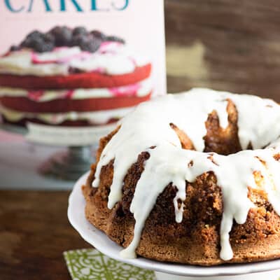 Pound cake on a cake stand topped with white icing.