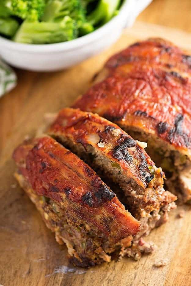 A close up of a piece of meatloaf on a cutting board