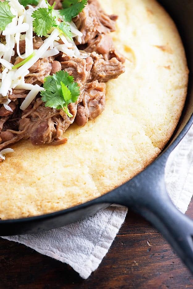 Slow cooker pork and beans! This is a cheap and easy slow cooker dinner that's perfect over cornbread. We love this for Mexican night! 