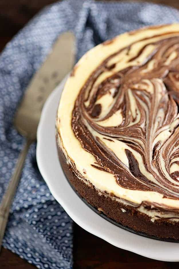 Chocolate cheesecake on a cake stand.