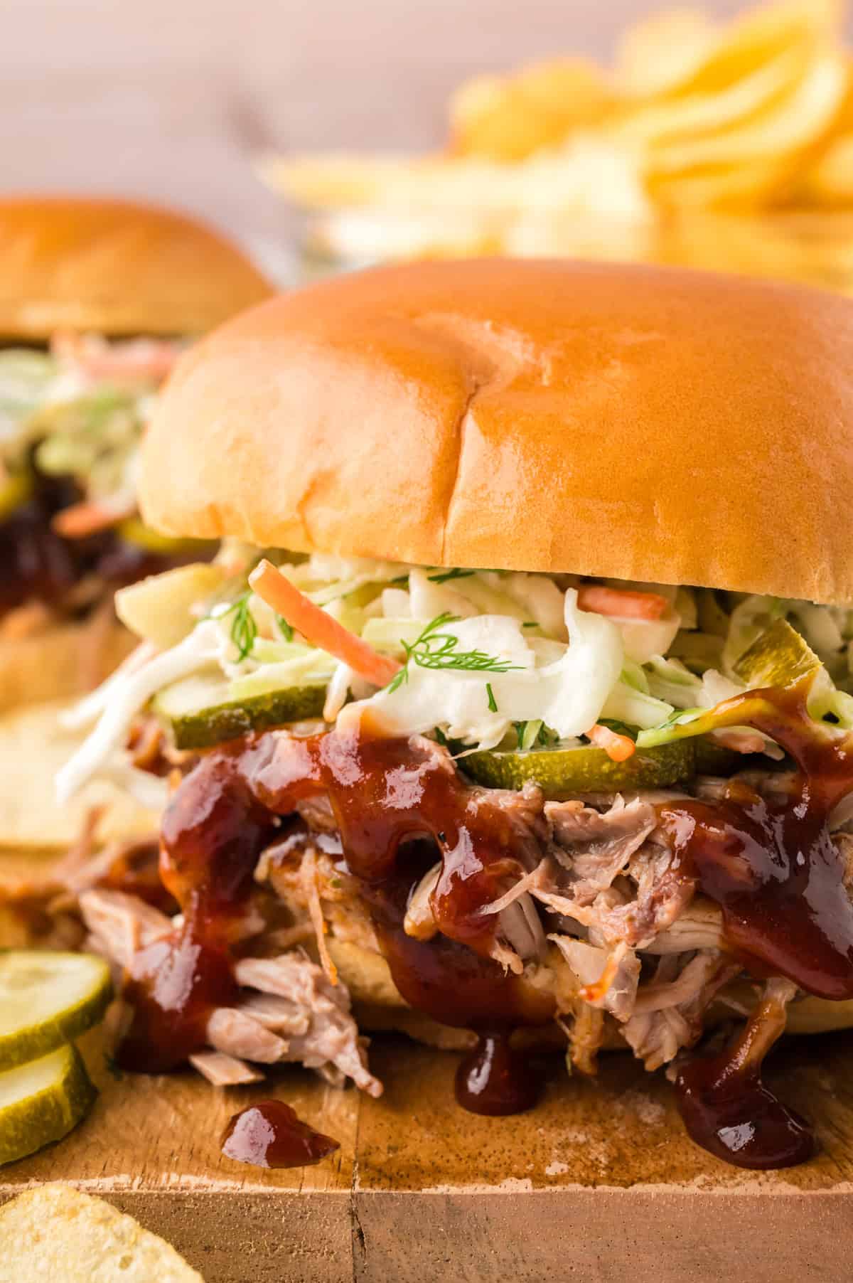 Pulled pork sandwich topped with dill slaw and pickles.