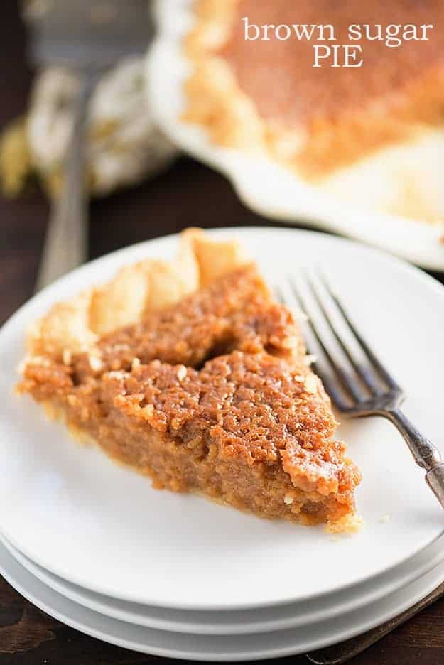 A close up of a piece of pie on a white plate with a fork.