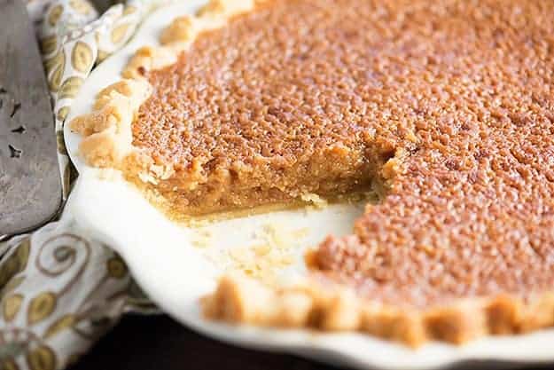 A slice of brown sugar pie removed from a pie plate.