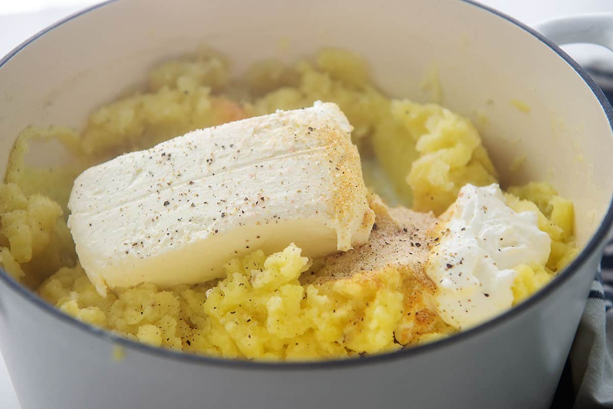 mashed potatoes with cream cheese and sour cream in pot.