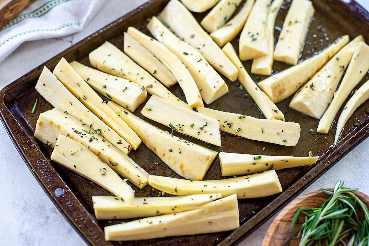 seasoned parsnips on baking sheet.