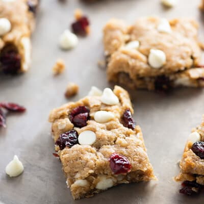 A few white chocolate oatmeal bars on a baking sheet.