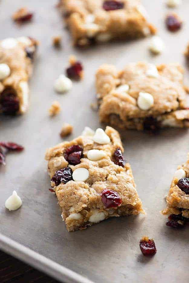 A few white chocolate oatmeal bars on a baking sheet.