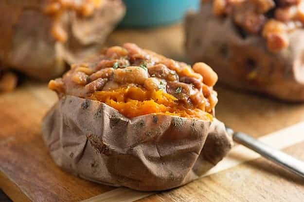 These crock pot baked beans are loaded with diced ham! Serve them over baked sweet potatoes for an easy dinner!