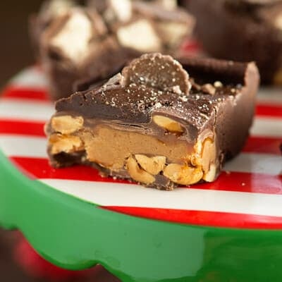 Chocolate peanut butter fudge on a red and white cake stand.