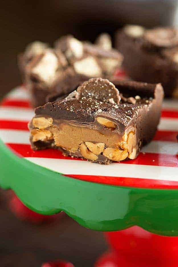 Chocolate peanut butter fudge on a red and white cake stand.