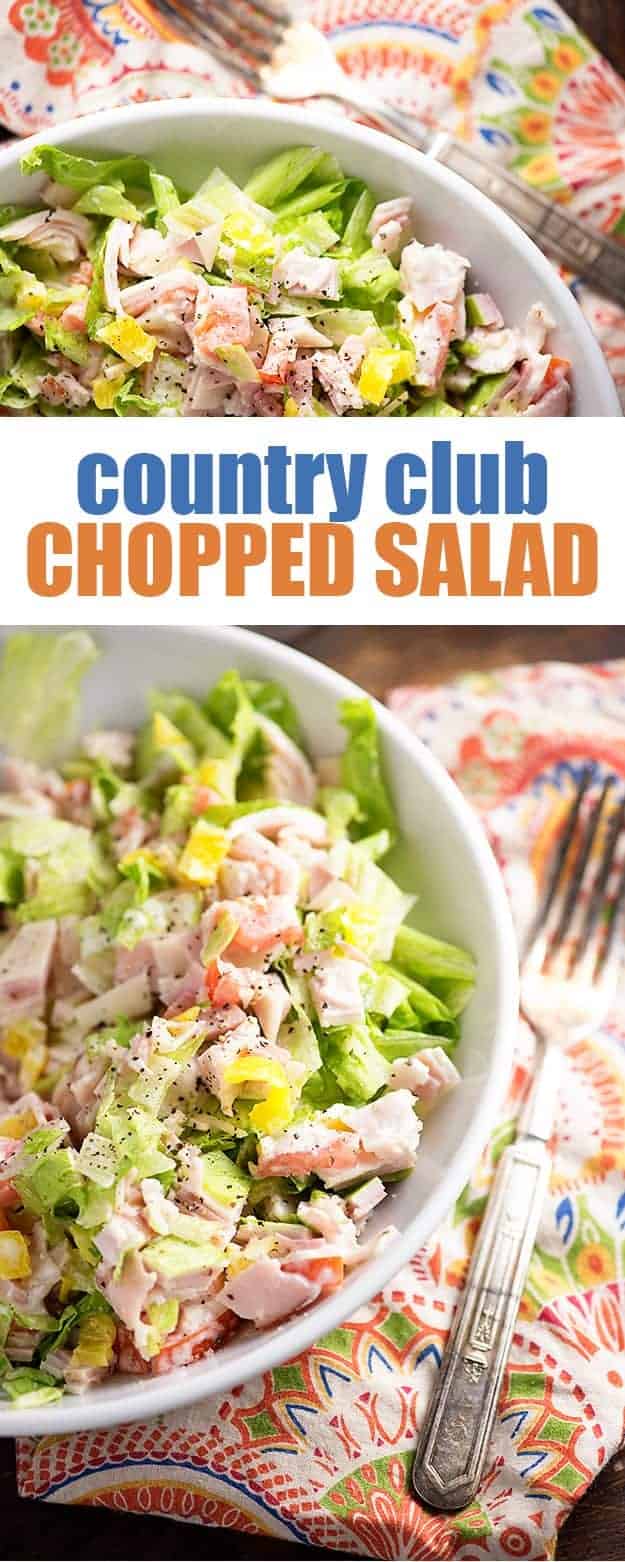 A close up of a bowl of chopped salad on a wooden table.