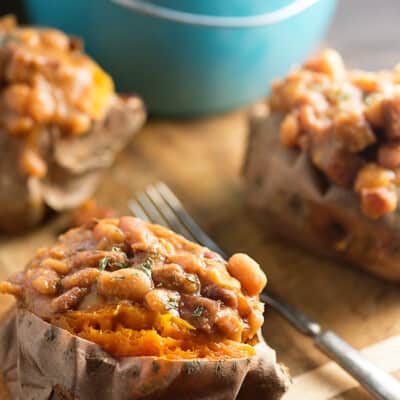 These crock pot baked beans are loaded with diced ham! Serve them over baked sweet potatoes for an easy dinner!