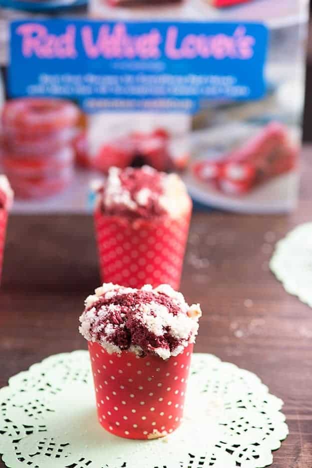 A red velvet muffin on a white lace placeholder.