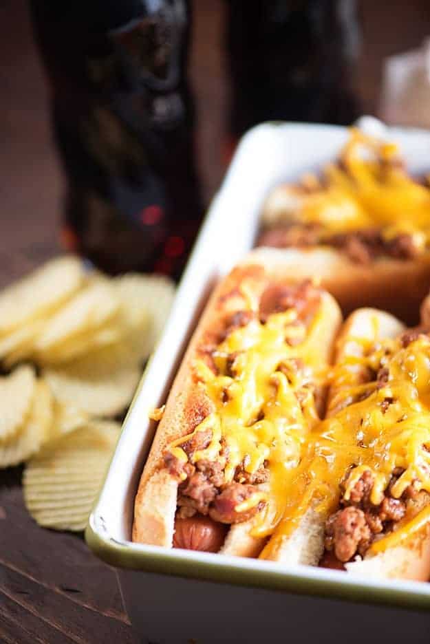 Cheesy sloppy joe hot dogs in a baking pan.