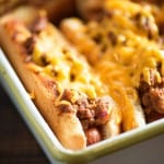 Oven Baked Sloppy Joe Dogs! They're cheesy and messy - perfect for a quick lunch or to feed the fans at the next football game!