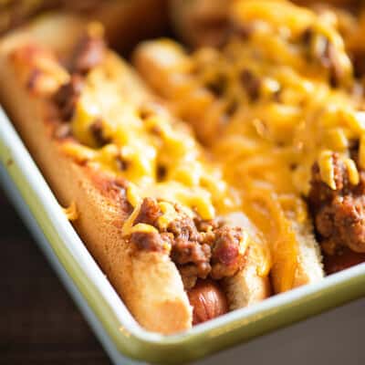 Oven Baked Sloppy Joe Dogs! They're cheesy and messy - perfect for a quick lunch or to feed the fans at the next football game!