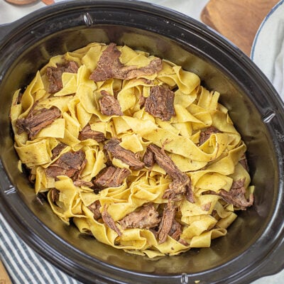 overhead view of beef and noodles in slow cooker.