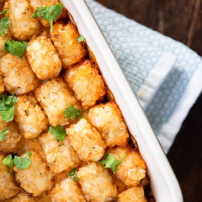 Tater tots in a white baking pan.